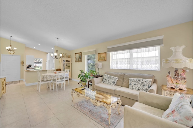 living room featuring an inviting chandelier, a textured ceiling, vaulted ceiling, and light tile patterned floors