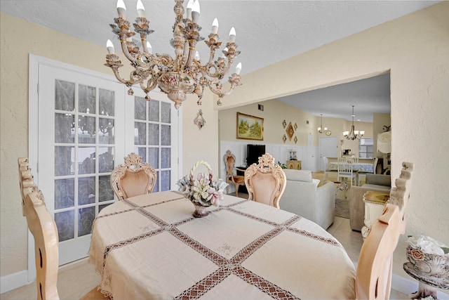 dining area featuring light tile patterned flooring and a chandelier