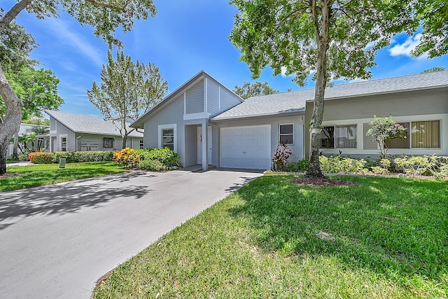 single story home with a front lawn, a garage, driveway, and stucco siding