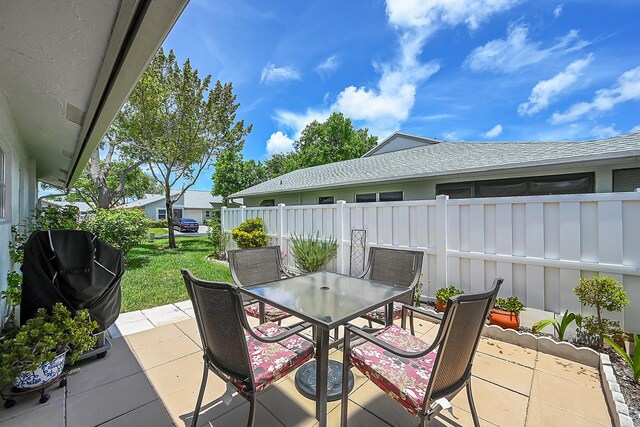 view of patio with outdoor dining space and fence