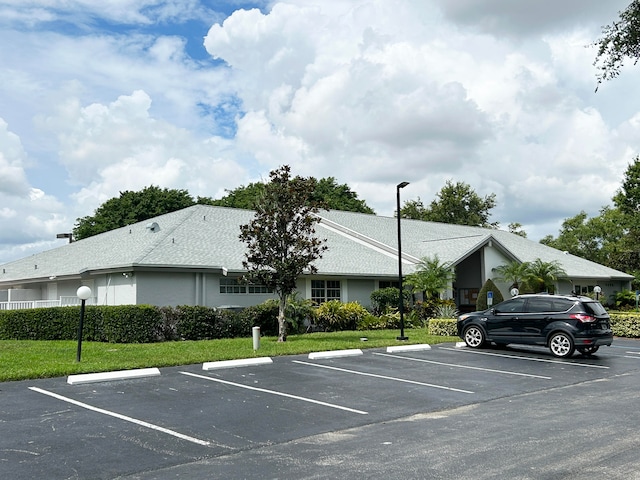 view of parking with a lawn