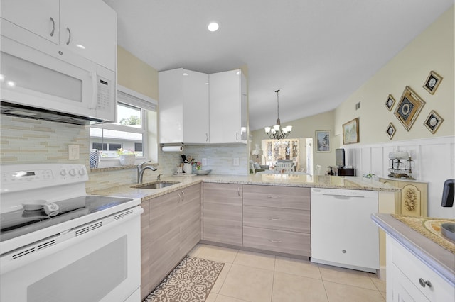 kitchen with tasteful backsplash, a notable chandelier, white appliances, light stone countertops, and a sink