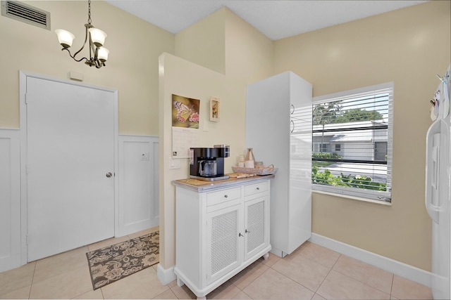 kitchen with decorative light fixtures, light tile patterned flooring, and a chandelier