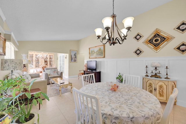 tiled dining area with a notable chandelier, a wealth of natural light, and lofted ceiling