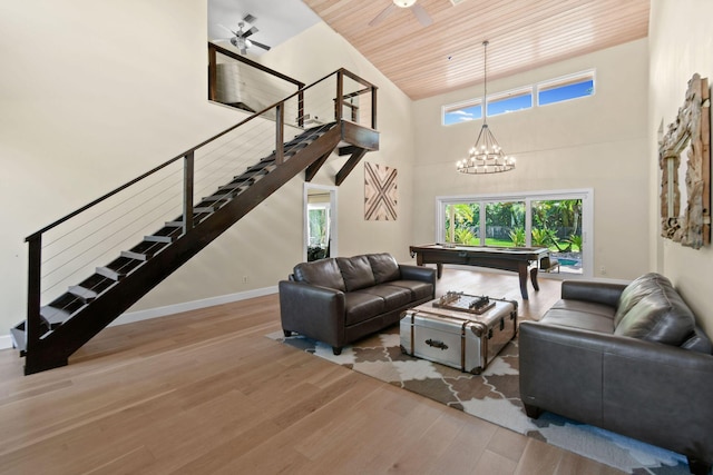 living room with pool table, light wood-type flooring, wooden ceiling, plenty of natural light, and a towering ceiling