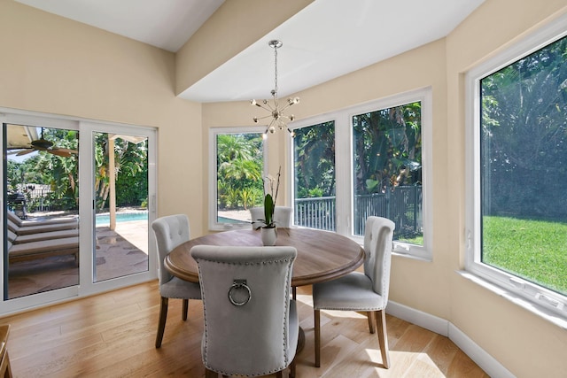 dining room with an inviting chandelier, light hardwood / wood-style flooring, and plenty of natural light