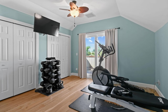 exercise room featuring lofted ceiling, ceiling fan, and light hardwood / wood-style flooring