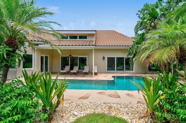 rear view of property with ceiling fan and a patio