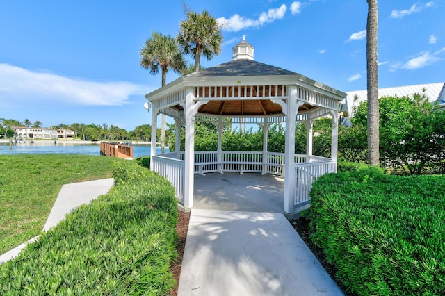 surrounding community with a yard, a gazebo, and a water view