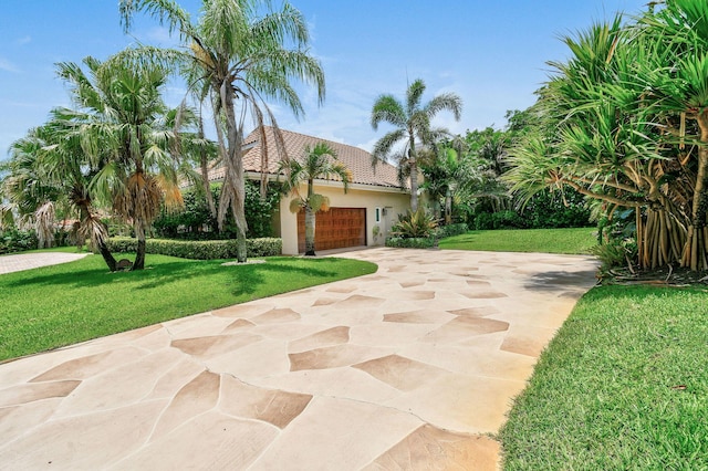 view of front of home with a garage and a front yard