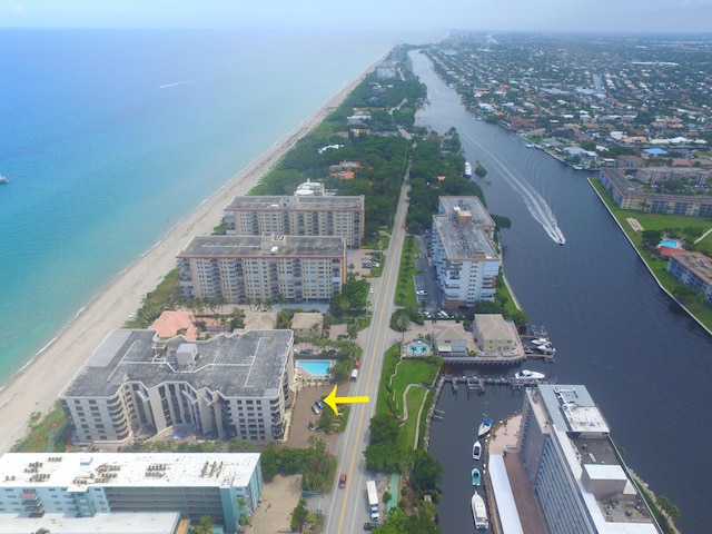 bird's eye view featuring a water view, a view of city, and a view of the beach