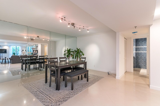 1155 Hillsboro Mile Unit 305, Hillsboro Beach, FL 33062 - dining area featuring baseboards, ornamental molding, and track lighting