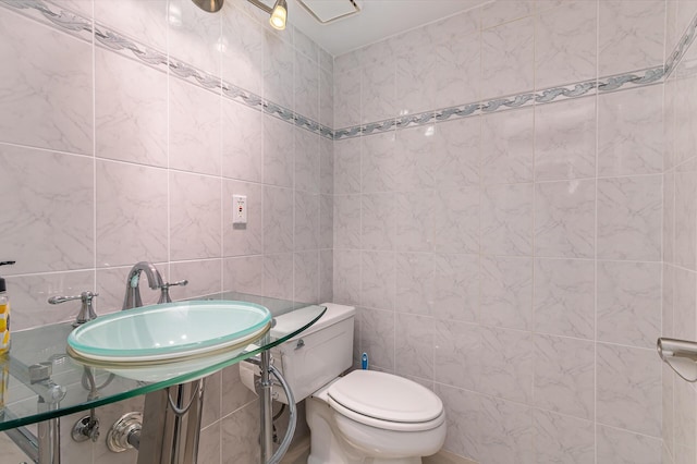 1155 Hillsboro Mile Unit 305, Hillsboro Beach, FL 33062 - half bathroom featuring a sink, tile walls, and toilet