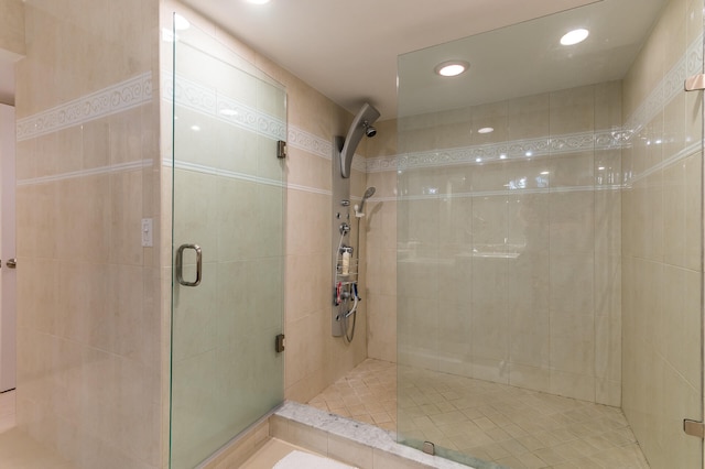 bathroom featuring a shower with shower door