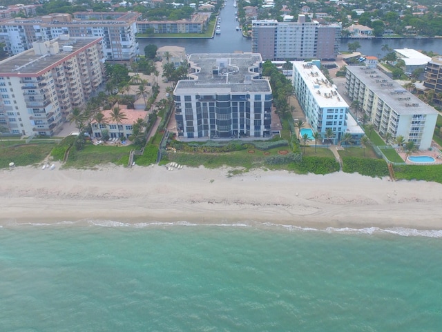 aerial view with a water view and a beach view