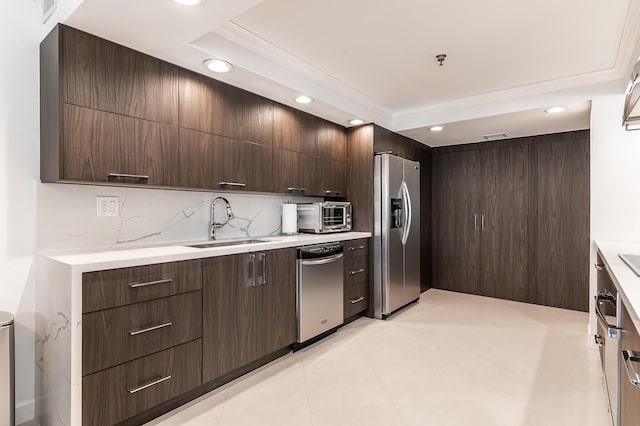 1155 Hillsboro Mile Unit 305, Hillsboro Beach, FL 33062 - kitchen featuring stainless steel appliances, a sink, decorative backsplash, and dark brown cabinetry