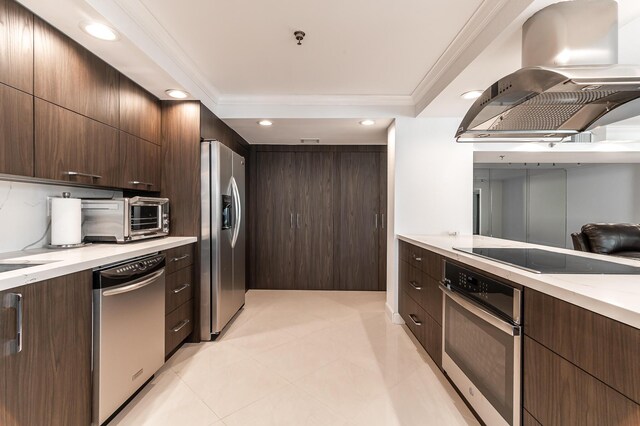 1155 Hillsboro Mile Unit 305, Hillsboro Beach, FL 33062 - kitchen with a toaster, stainless steel appliances, dark brown cabinets, ornamental molding, and island exhaust hood