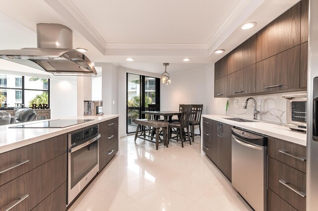 1155 Hillsboro Mile Unit 305, Hillsboro Beach, FL 33062 - kitchen featuring stainless steel appliances, a tray ceiling, a sink, and island range hood