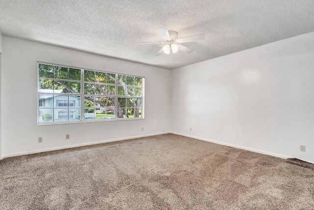 carpeted spare room with ceiling fan, baseboards, and a textured ceiling