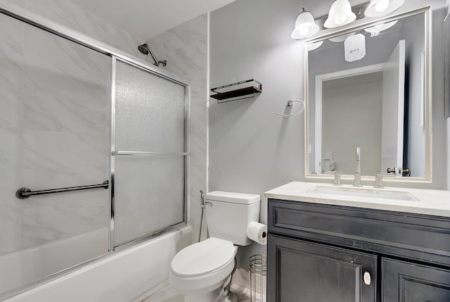 full bathroom featuring bath / shower combo with glass door, toilet, and vanity