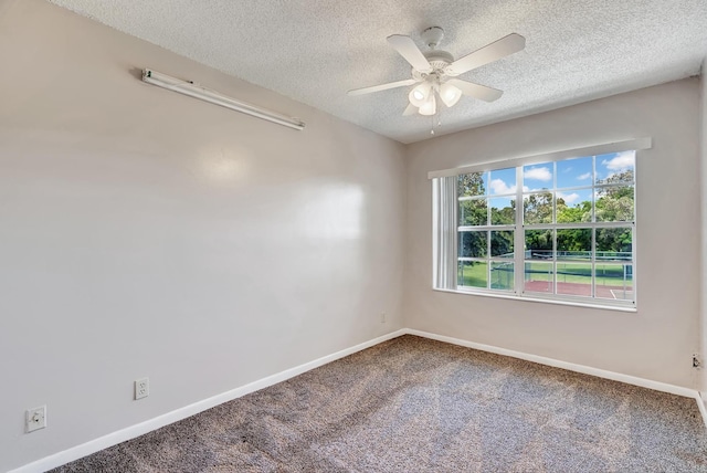 carpeted empty room featuring a ceiling fan, baseboards, and a textured ceiling