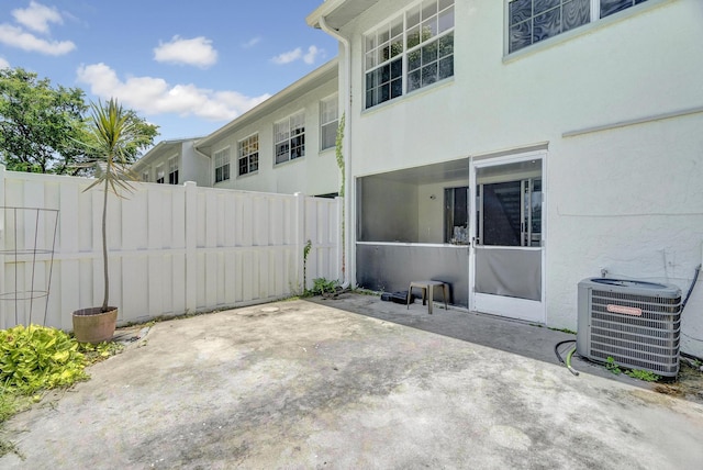 view of patio featuring central AC and fence