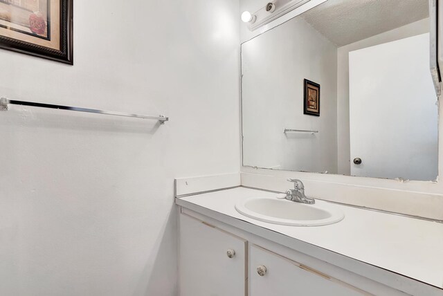 bathroom featuring vanity and a textured ceiling