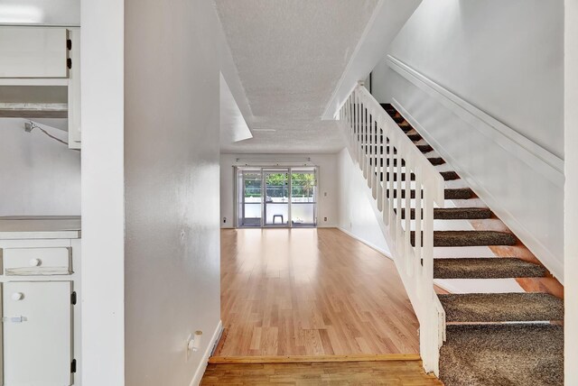 interior space featuring light hardwood / wood-style flooring and a textured ceiling