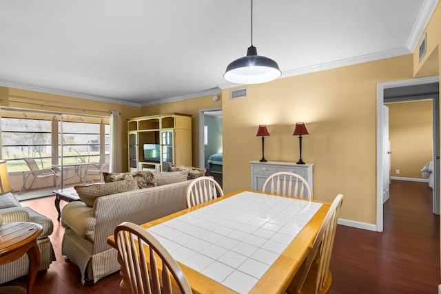 dining space featuring ornamental molding and dark hardwood / wood-style floors