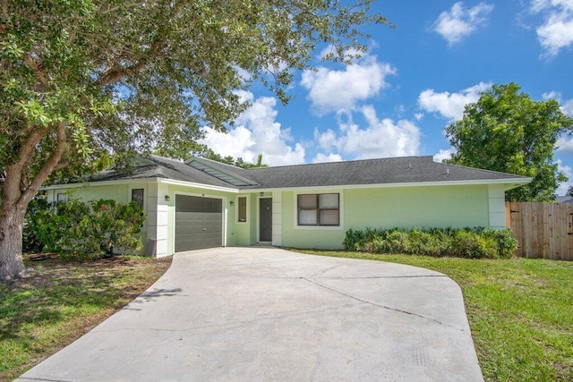 single story home with a front yard and a garage