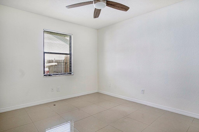 tiled spare room with ceiling fan