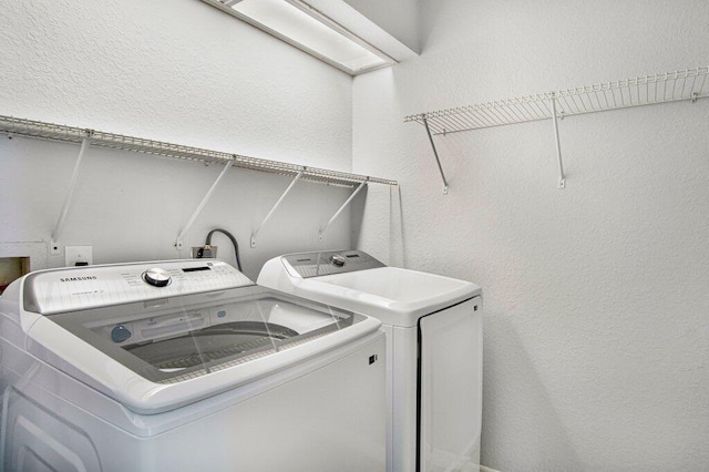 washroom with washer and dryer