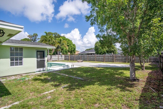 view of yard with a fenced in pool and a patio area