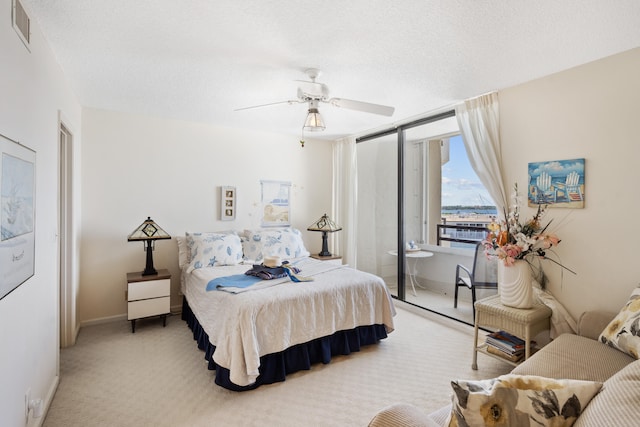 bedroom with carpet, a textured ceiling, and ceiling fan