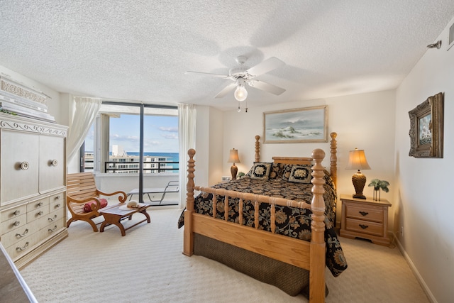 bedroom with access to outside, light carpet, ceiling fan, and a textured ceiling