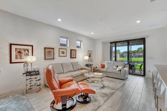 living room featuring plenty of natural light and light hardwood / wood-style flooring