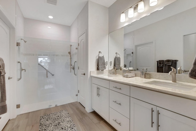 bathroom with vanity, hardwood / wood-style flooring, and an enclosed shower