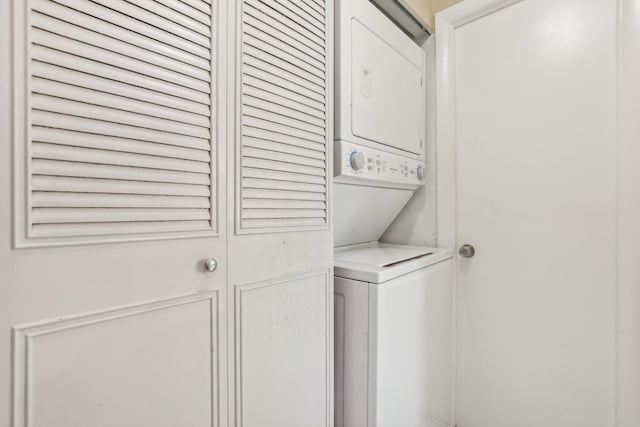 laundry room with stacked washer / dryer