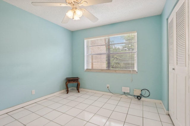 unfurnished bedroom featuring light tile patterned flooring, a closet, and ceiling fan