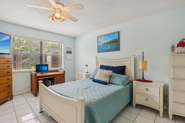 tiled bedroom featuring ceiling fan and a textured ceiling