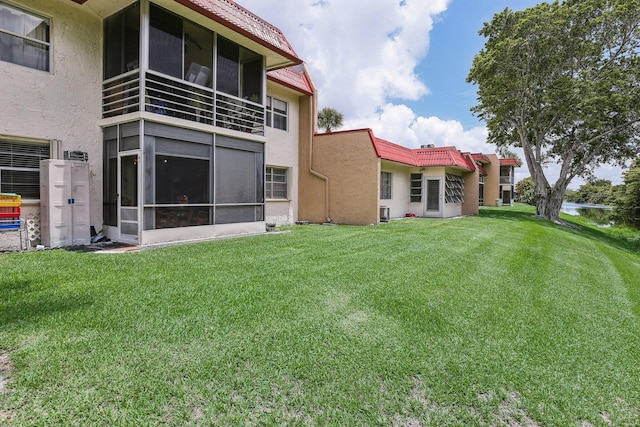 rear view of house with a yard