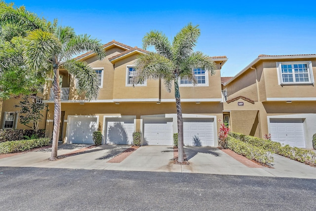 view of property with a garage and a balcony