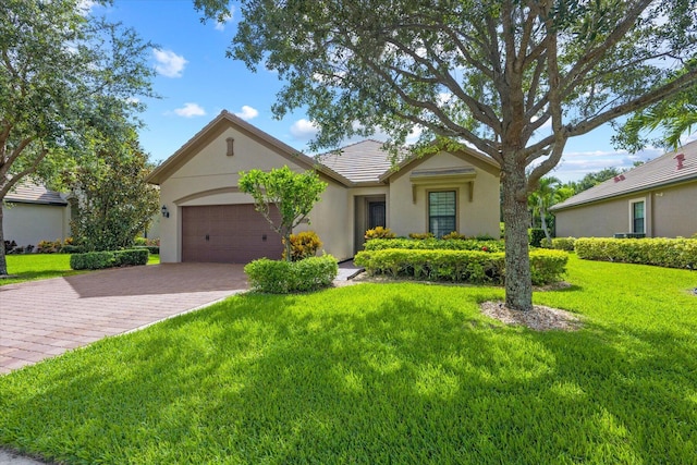 ranch-style home with a front lawn and a garage