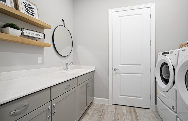 bathroom with baseboards, independent washer and dryer, vanity, and wood tiled floor