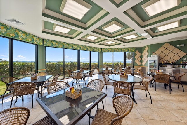 sunroom / solarium featuring beam ceiling, plenty of natural light, and coffered ceiling