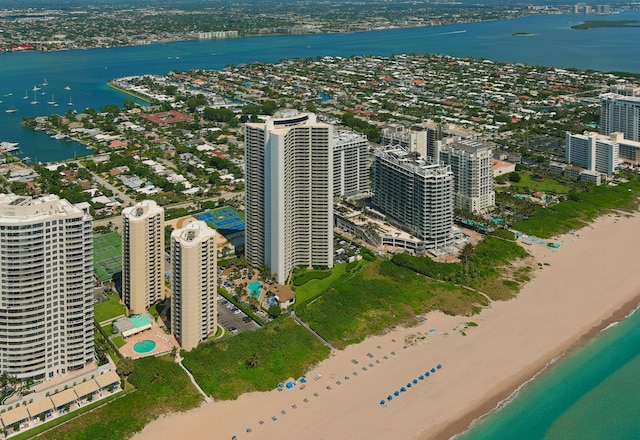 birds eye view of property with a beach view and a water view