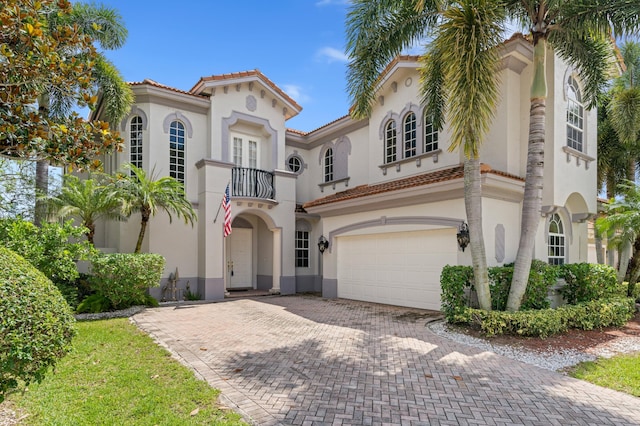 mediterranean / spanish-style house featuring a balcony and a garage