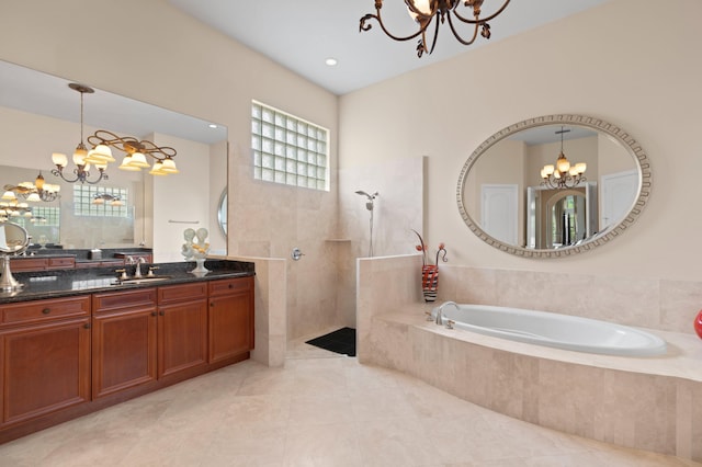 bathroom with an inviting chandelier, tile patterned floors, independent shower and bath, and vanity