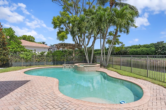 view of swimming pool featuring an in ground hot tub and a patio area