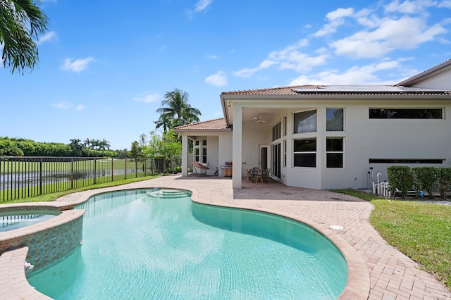 view of pool featuring a patio and an in ground hot tub